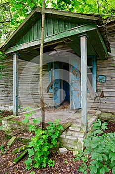 One-story wooden building of abandoned primary school in resettled village of Dronki in exclusion zone of Chernobyl nuclear power