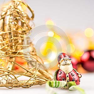 One straw christmas bell and one ceramic santa claus