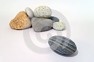 One striped rock in front of other rocks