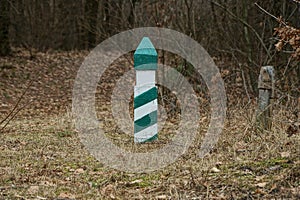 One striped signal pole among the dry gray grass