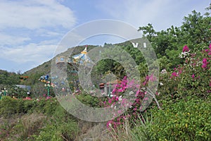 Nha Trang, Viet Nam - 13 July,2015: Beautiful landscape with colorful Swing Carousel game in amusement park with green mountain