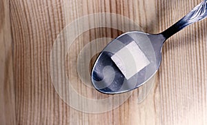 One Sugar Cube on a Silver Spoon