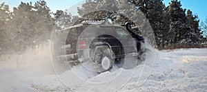 One SUV 4x4 cars go on snowy road, winter season