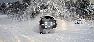 One SUV 4x4 cars go on snowy road, winter season