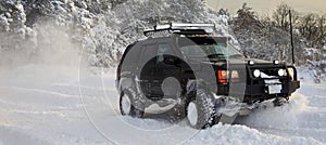 One SUV 4x4 cars go on snowy road, winter season