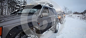 One SUV 4x4 cars go on snowy road, winter season