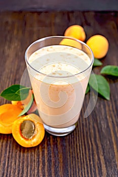 Milkshake apricot in high glassful on board