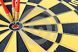 One target with three arrows hitting the bullseye