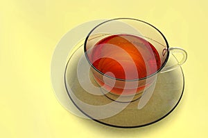 One tea cup, transparent glass, on light background