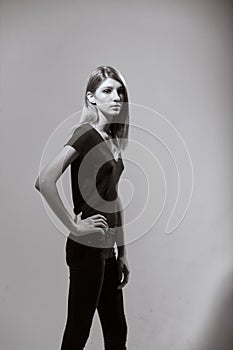 One teenage girl, standing, fashion model, posing, looking to camera.