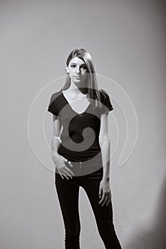One teenage girl, standing, fashion model, posing, looking to camera.