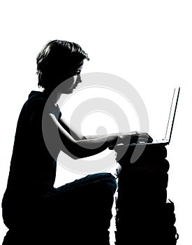 One teenager silhouette computer computing lap