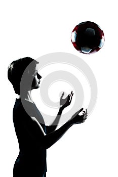 One teenager silhouette tossing soccer football