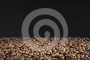 one third of freshly roasted brown coffee beans with two thirds