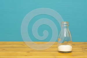 One-third pint glass bottle with dregs of fresh milk