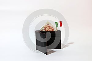 One thousand Lire of Italy banknote and mini Italia nation flag stick on the black wallet with white background