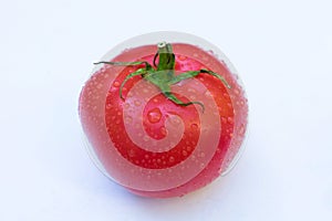 One tomato on a white background.Close-up.