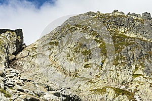 One tourist on the trail and the other on the nearby via ferrata to Priecne sedlo (Czerwona Lawka) in the Slovak Tatras