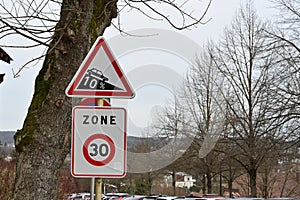 One triangle traffic sign with red border colour indicating 10 percent downhill gradient.