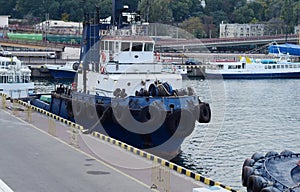 One of the tugboats is at the pier.