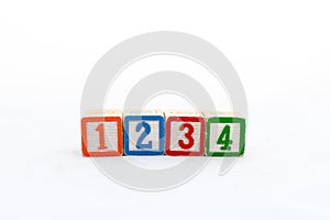 one, two, three and four number wooden blocks isolated on white background