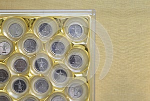 One UAE Dirham coins placed in a slotted gift box.