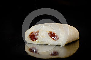 One uncooked mini homemade bun with chocolate filling in electric oven