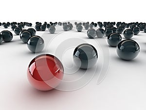 One unique red ball, among other black