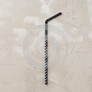 One use plastic disposable drinking straw on concrete background