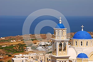 One of the views of iconic Blue Domes Church with Aegean Sea behind along Street 25 Martiou, Thira, Santorini, Greece