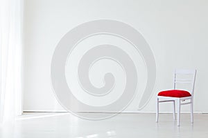 One vintage chair in the interior of an empty white room