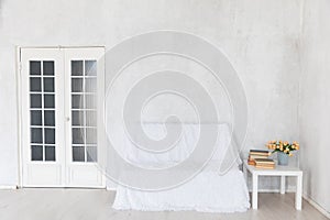 One vintage sofa chair against the wall in an empty white room