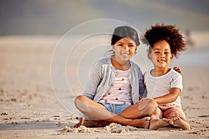 One is always the watcher, one the dancer. two sisters spending time together at the beach.