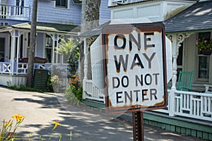 One way do not enter black & white sign with rusted edges on a s