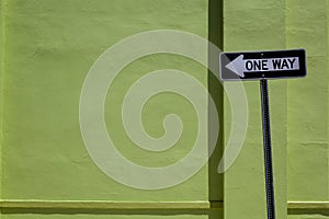 One Way Sign & Green Wall