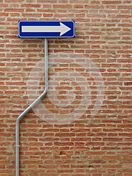 One way sign over a bricks wall