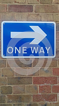 One way sign pointing one way on a wall in Sydenham south London u.k