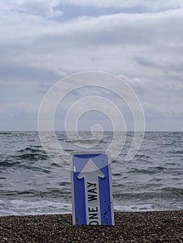 One way sign and seascape