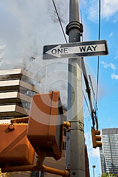 One way street sign and steam