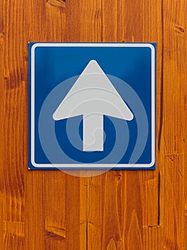 One way traffic sign on wooden wall