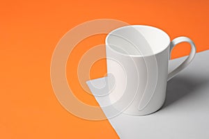 One white ceramic mug on color background, space for text