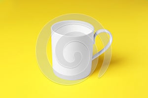 One white ceramic mug on yellow background