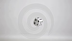 One white dice in a super slow motion rebounding