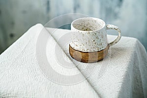 One white handemade ceramic cup