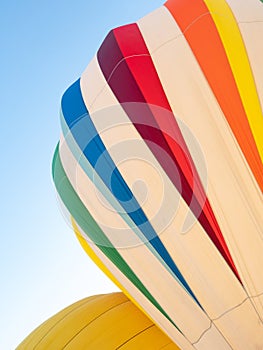 One White Hot Air Balloon with Colorful Accents and a Gold Hot A photo