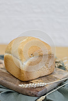 One white round bread with wheat fiber on the table.