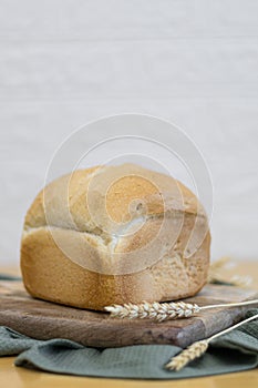 One white round bread with wheat fiber on the table.