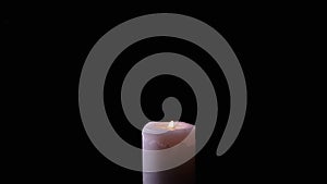 One White Wax Candle Burning in a Cloud of Thick Smoke on a Black Background