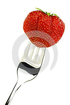 One whole fresh strawberry on a fork