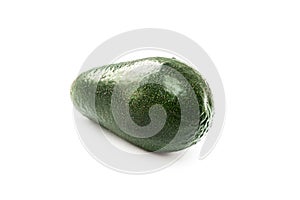 One whole green avocado on a white isolated background